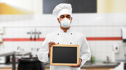 Image showing chef in respirator with chalkboard at kitchen