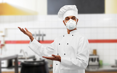 Image showing male chef in respirator at restaurant kitchen