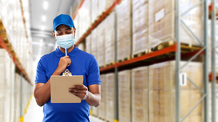 Image showing delivery man in face protective mask at warehouse