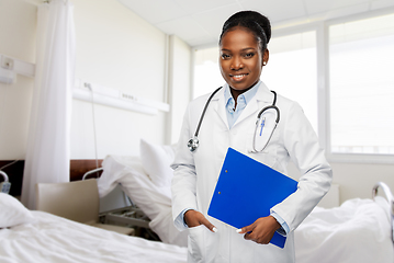 Image showing happy african doctor with clipboard at hospital