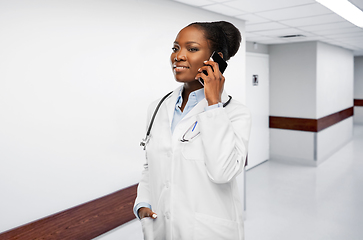 Image showing african female doctor calling on smartphone