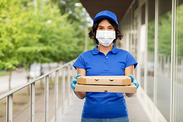 Image showing delivery woman in mask with pizza boxes outdoors