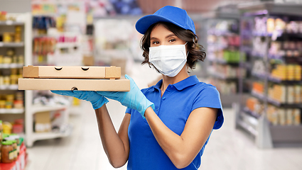 Image showing delivery woman in mask with pizza boxes at store