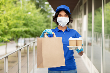 Image showing delivery girl in mask with food and drinks in city