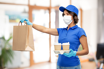 Image showing delivery girl in mask with food at office