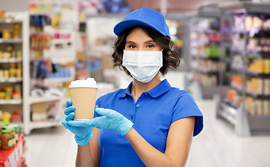 Image showing saleswoman in mask with coffee cup at store