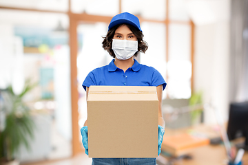 Image showing delivery woman in mask with parcel box at office