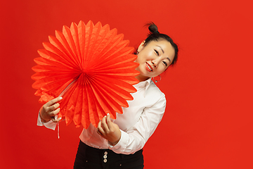 Image showing Happy Chinese New Year. Asian young woman portrait isolated on red background