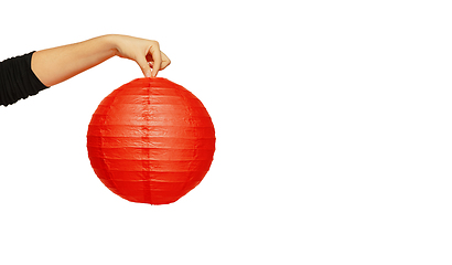 Image showing Happy Chinese New Year. Female hand holding lantern on white background