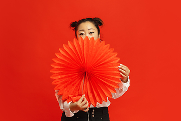 Image showing Happy Chinese New Year. Asian young woman portrait isolated on red background