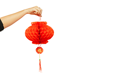 Image showing Happy Chinese New Year. Female hand holding lantern on white background