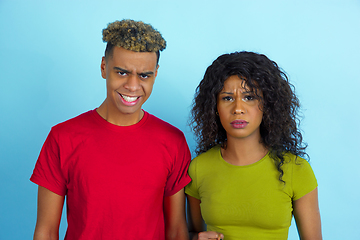 Image showing Young emotional african-american man and woman on blue background