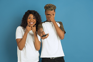 Image showing Young emotional african-american man and woman on blue background