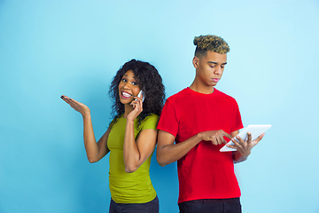 Image showing Young emotional african-american man and woman on blue background