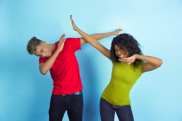 Image showing Young emotional african-american man and woman on blue background