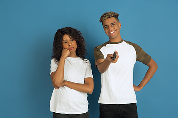 Image showing Young emotional african-american man and woman on blue background
