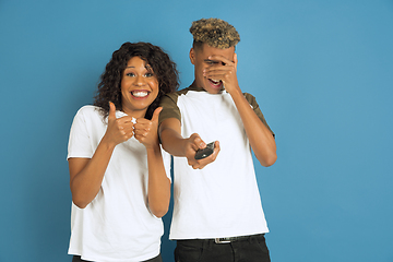 Image showing Young emotional african-american man and woman on blue background