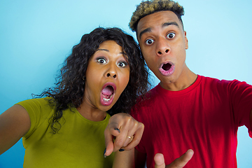 Image showing Young emotional african-american man and woman on blue background