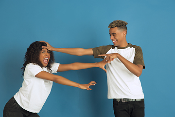 Image showing Young emotional african-american man and woman on blue background