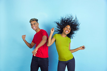 Image showing Young emotional african-american man and woman on blue background