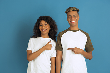 Image showing Young emotional african-american man and woman on blue background