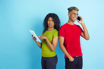 Image showing Young emotional african-american man and woman on blue background