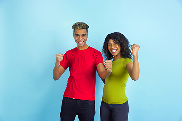 Image showing Young emotional african-american man and woman on blue background