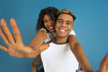 Image showing Young emotional african-american man and woman on blue background