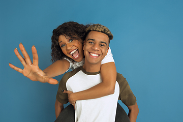 Image showing Young emotional african-american man and woman on blue background