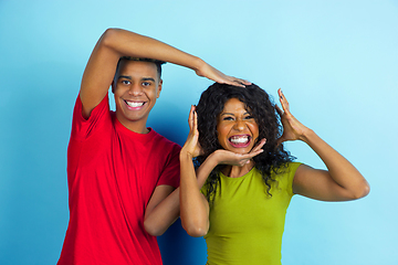 Image showing Young emotional african-american man and woman on blue background