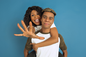 Image showing Young emotional african-american man and woman on blue background