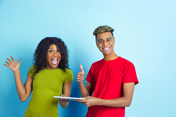 Image showing Young emotional african-american man and woman on blue background