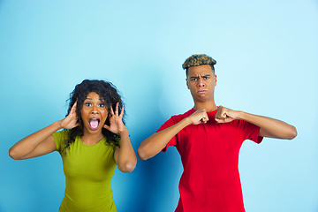 Image showing Young emotional african-american man and woman on blue background