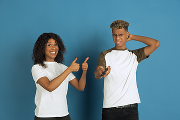 Image showing Young emotional african-american man and woman on blue background