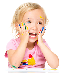 Image showing Little girl is holding her face in astonishment