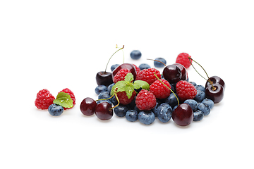 Image showing blueberry, cherry and raspberry berries isolated on white background