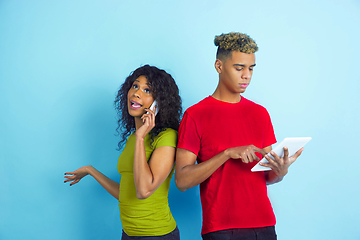 Image showing Young emotional african-american man and woman on blue background