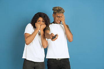 Image showing Young emotional african-american man and woman on blue background