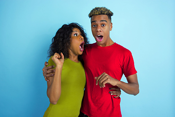 Image showing Young emotional african-american man and woman on blue background