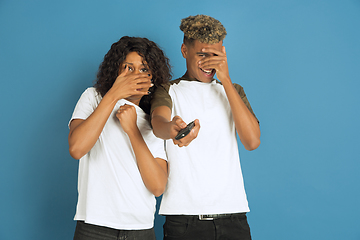 Image showing Young emotional african-american man and woman on blue background