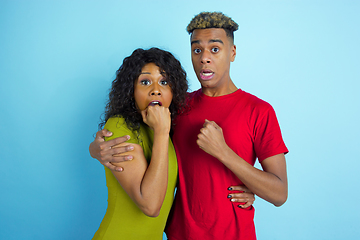 Image showing Young emotional african-american man and woman on blue background