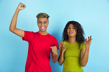 Image showing Young emotional african-american man and woman on blue background