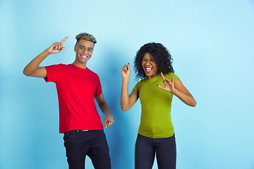 Image showing Young emotional african-american man and woman on blue background