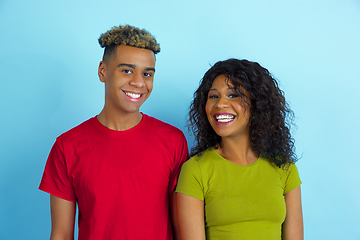 Image showing Young emotional african-american man and woman on blue background