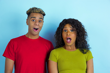 Image showing Young emotional african-american man and woman on blue background