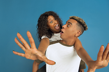 Image showing Young emotional african-american man and woman on blue background