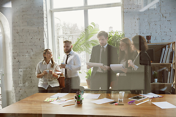 Image showing Group of young business professionals having a meeting, creative office