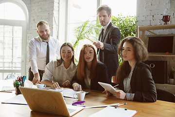 Image showing Group of young business professionals having a meeting, creative office