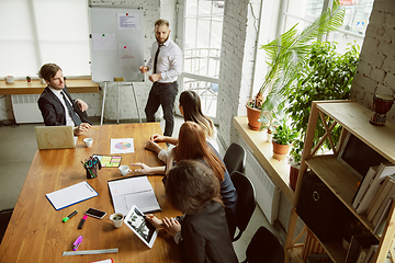 Image showing Group of young business professionals having a meeting, creative office