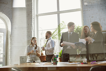 Image showing Group of young business professionals having a meeting, creative office